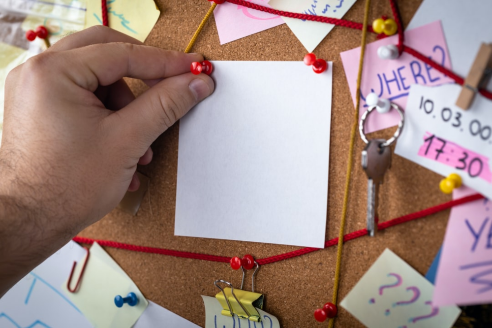 bulletin board with lots of things pinned to the board