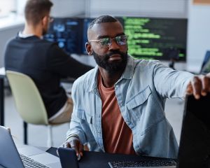Man touching computer monitor