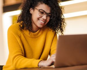 Woman smiling while working on a computer
