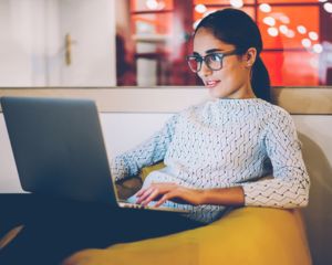 Woman sitting on a couch while 