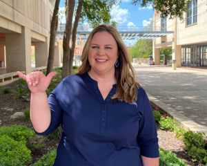 Stephanie Stout holding up "Roadrunner" hand sign
