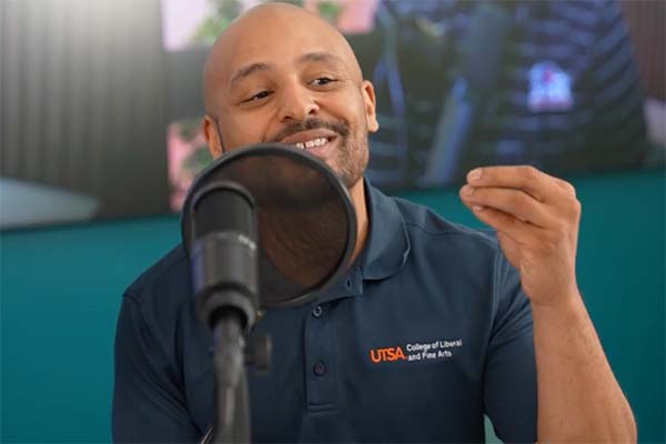 A faculty member records a podcast